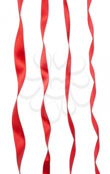 Collection of various red ribbon pieces on white background