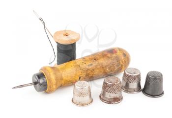 Spool of thread with needle and awl