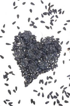 Sunflower seeds on white background. Heart