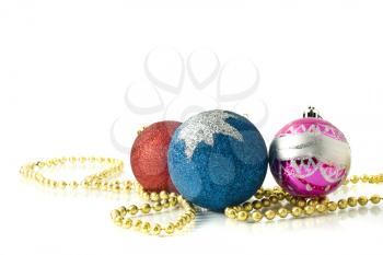 Christmas decoration - red, pink and blue balls with beads over white
