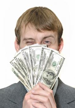 Happy winking businessman holding money isolated on white