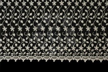 Lacy cloth with flowers pattern over black background