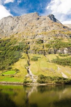 Mountain of norwegian fjord in Norway. Clouds and blue sky