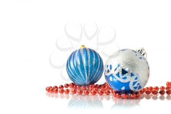 Christmas comes -  two blue balls and red beads over white