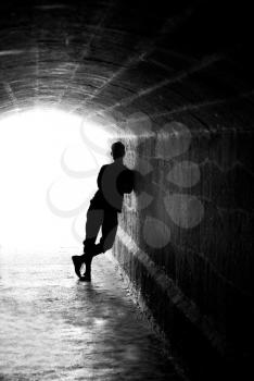 Human silhouette in back lighting in tunnel exit (shallow DOF)