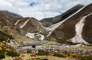 Life in Nepal: highland village and peaks in Himalayas. Travel to Nepal