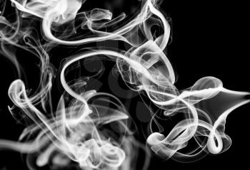 White abstract puff of smoke over black background