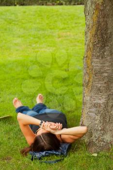 Royalty Free Photo of a Girl Lying in the Shade