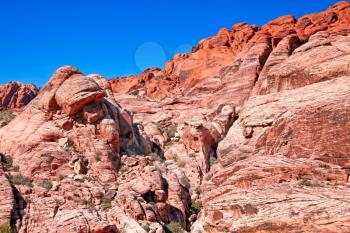 View of dry landscape and red rock formations of the Red Rock Canyon in the Mojave Desert.