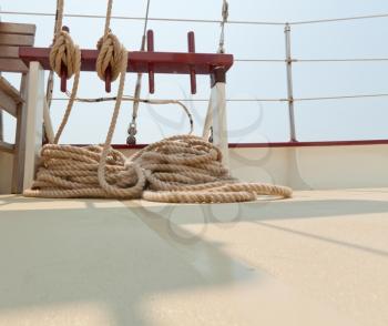 Coiled rope rigging on a sailboat deck.