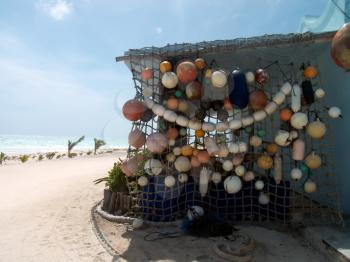 Colorful fishnet floats on the caribbean beach.