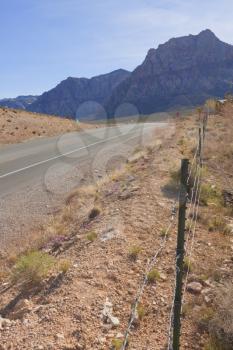 View of dry landscape and red rock formations of the Mojave Desert..