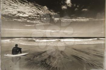 Sandy beach with a surfer.