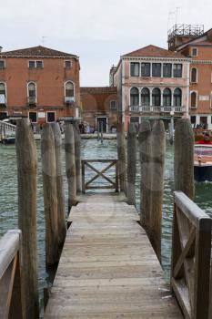 Venice, Italy - April 1, 2013: Street views of canals and ancient architecture in Venice, Italy. Venice is a city in northeastern Italy sited on a group of 118 small islands separated by canals and li