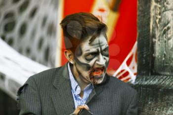 Jackson, USA-September 24, 2016: Street performer in Halloween costume and makeup is entertaining crowds.