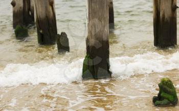 Old jetty in the ocean wave splash.