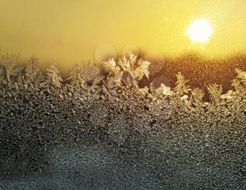 frosty natural pattern and sun on winter window