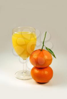 orange juice and two mandarin fruits