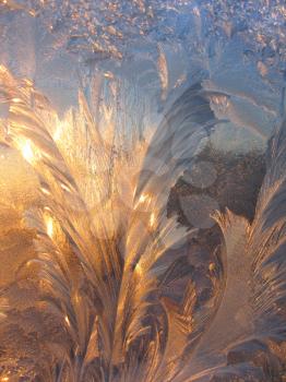 ice pattern and sunlight on winter glass