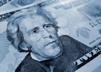 closeup of new twenty american dollars - abstract blue background