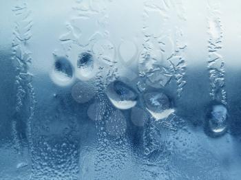 natural water drops and frost on winter glass