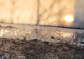 frost and sun on winter window glass

