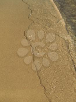 Transparent sea wave on the sand                      
