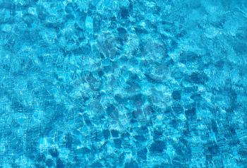 Blue ripped water in swimming pool shining background