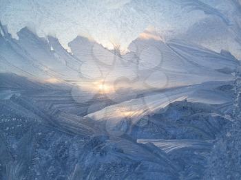 Beautiful ice pattern and sunlight on winter glass