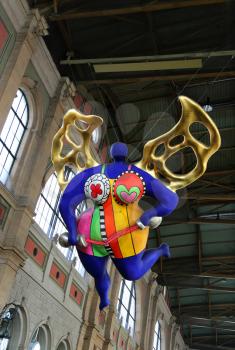 ZURICH HB, SWITZERLAND - MARCH 16, 2015: View of a statue of a guardian angel by Niki de Saint Phalle situated inside of the main train station in Zurich 