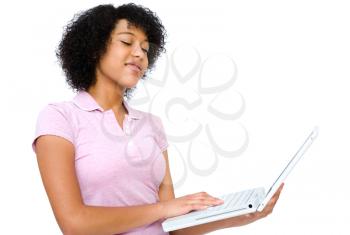 Royalty Free Photo of a Teenage Girl Standing and Holding her Laptop