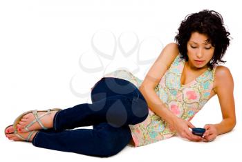 Royalty Free Photo of a Woman Lying on the Floor Texting on her Mobile Phone