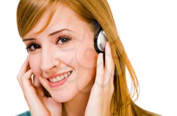 Royalty Free Photo of a Woman Smiling and Listening to Music on Headphones