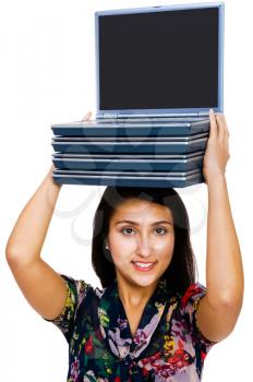 Royalty Free Photo of a Woman Carrying a Stack of Laptops on her Head