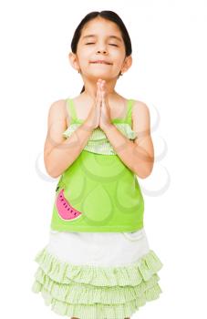 Close-up of a girl standing in prayer position isolated over white
