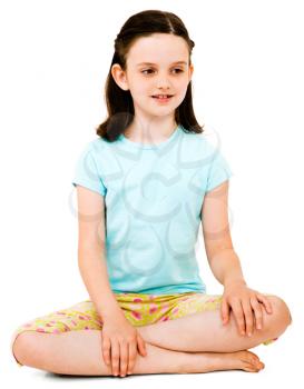 Smiling girl thinking and sitting isolated over white