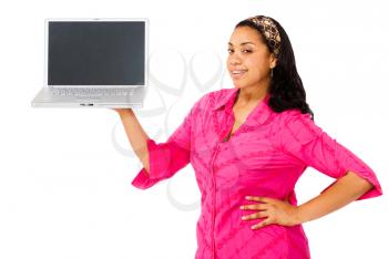 Young woman showing a laptop and smiling isolated over white