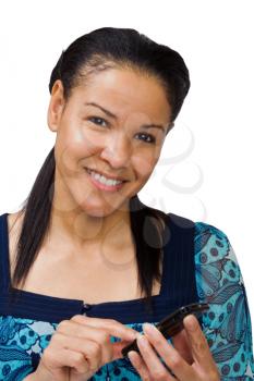 Woman text messaging on a mobile phone and smiling isolated over white