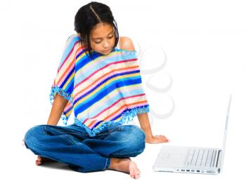 Latin American and Hispanic girl sitting near a laptop isolated over white