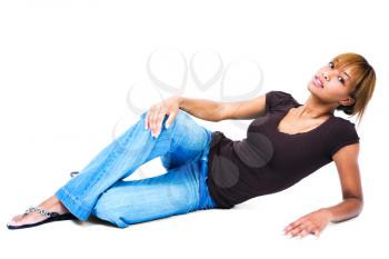Young woman leaning on the floor and posing isolated over white