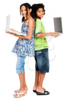 Two girls holding laptops and smiling isolated over white