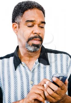 African American man text messaging on a mobile phone isolated over white