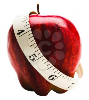 Measuring tape wrapped around red apple isolated over white
