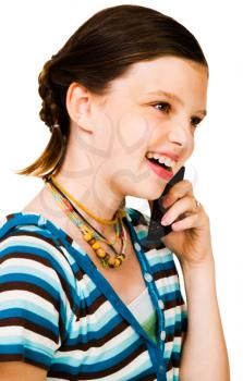 Confident girl talking on a mobile phone isolated over white