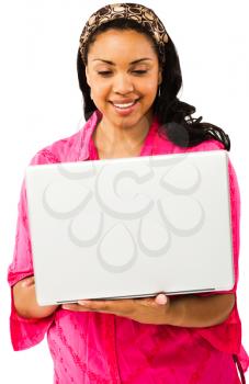 Confident young woman using a laptop isolated over white