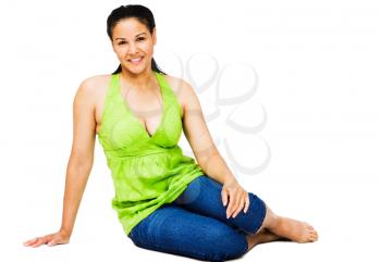 Smiling young woman sitting and posing isolated over white