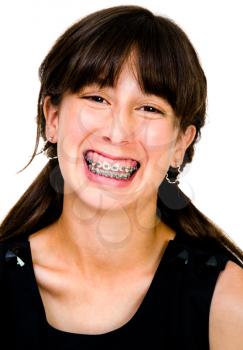 Confident teenage girl posing and smiling isolated over white