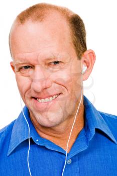 Portrait of a man listening to music and smiling isolated over white
