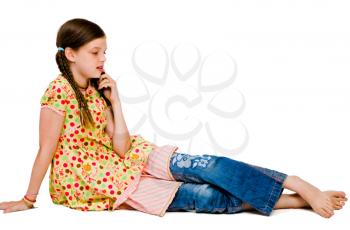 Cute girl talking on a mobile phone isolated over white
