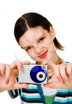 Happy girl holding a camera and photographing isolated over white